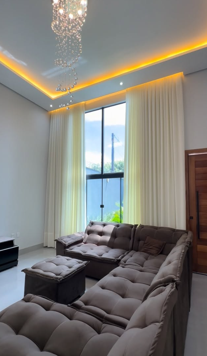 Sala de estar com pé-direito alto e cortina blackout em linho creme